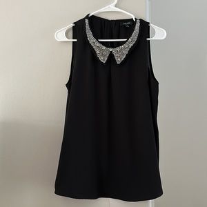 Black blouse with embellished collar .